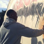 Vernon Davis autographing our mural